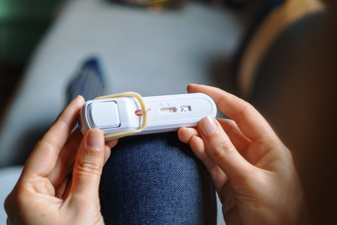 person looking at ng precision pregnancy test with a negative result